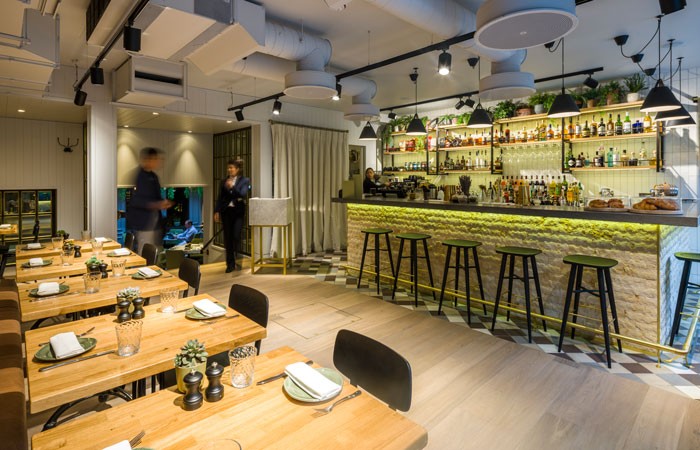 web-The-cafe-bar-space-with-greeting-station-positioned-before-the-stairs-down-into-the-restaurant