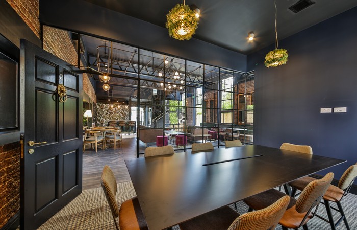 Design-Insider--study-rooms-to-the-rear-of-the-ground-floor-are-divided-by-a-glazed-wall-and-residential-style-doors